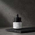 Cosrx skincare serum bottle with dropper on a dark background